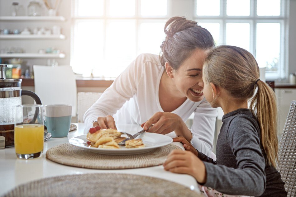 Mom and Daughter eat Pancakes for Breakfast 